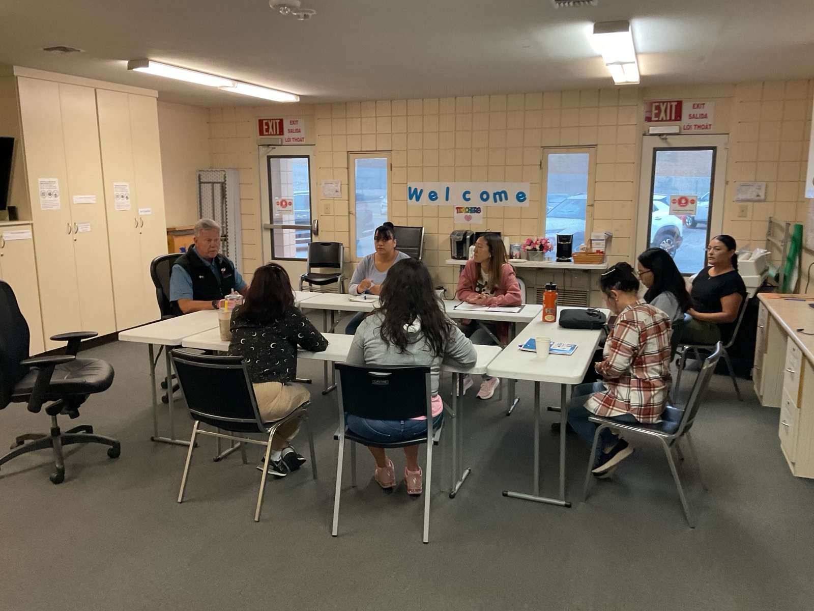 ICP assessor in discussion with childcare staff around a table