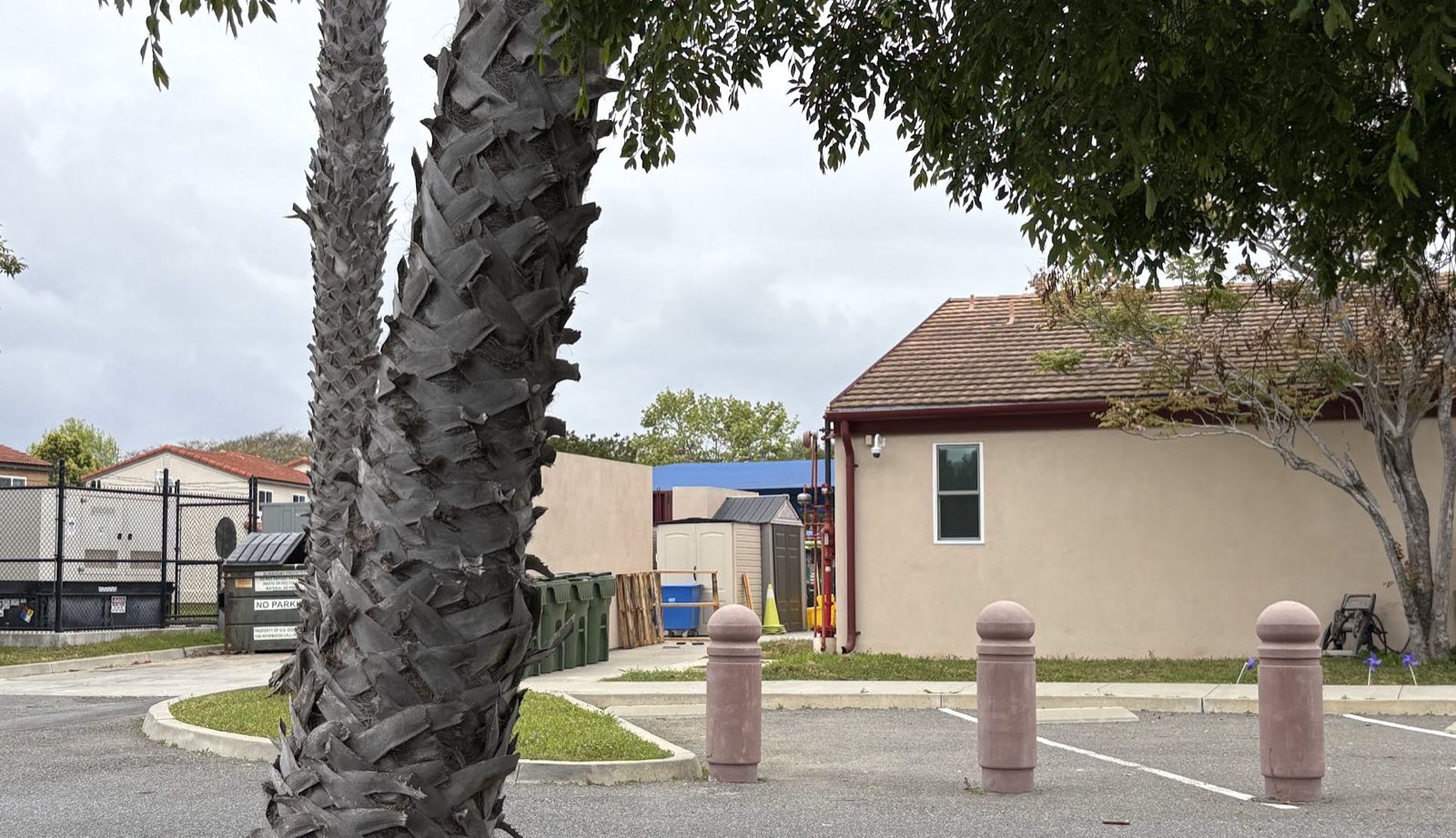 Decorative concrete bollards lining the parking spaces in front of an early childhood facility